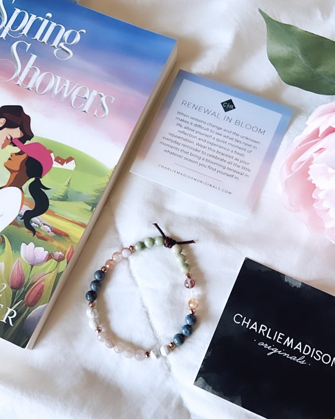 A Spring themed romance novel, Spring Showers by Sarah Dressler, pairs with a custom designed gemstone bracelet by jewelry designer Charlie Madison Originals